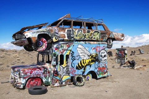 Cars sunk into the ground and sprayed with graffiti