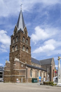 Church and gilded equestrian statue on market square remembering Battle of the Silver Helmets