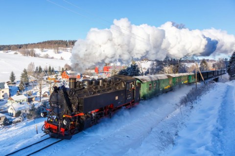 Steam train of the Fichtelbergbahn railway Steam locomotive in winter in Sehmatal