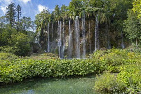 Waterfall and green tufa lake in the Plitvice Lakes National Park