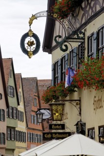 Late medieval townscape with hotel and nose sign