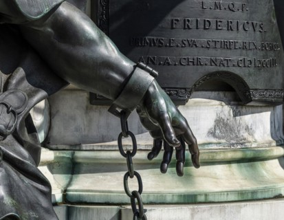 Detail photo of the chained warriors at the base of the equestrian statue of Frederick William of Brandenburg