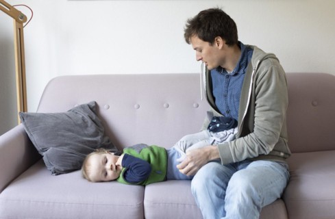 Subject: Father dresses a child aged nine months
