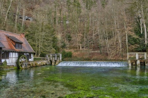 The Blautopf with historic hammer mill in Blaubeuren on the eastern edge of the Swabian Alb near Ulm