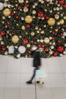 People stand out against Christmas decorations in a shopping centre on Schlossstrasse in Berlin