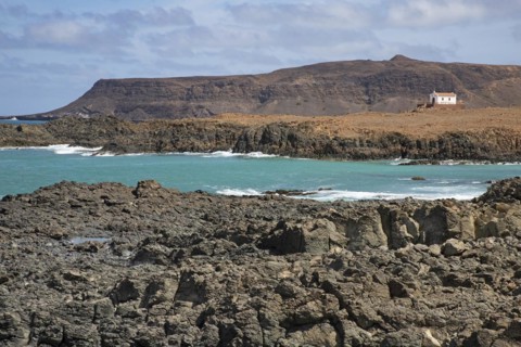 Praia de Fatima and abandoned chapel of Our Lady of Fatima looking over the rugged coast and cliffs near Sal Rei on the island Boa Vista