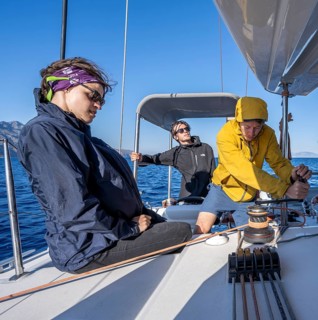Sailor operating a winch with halyard stopper