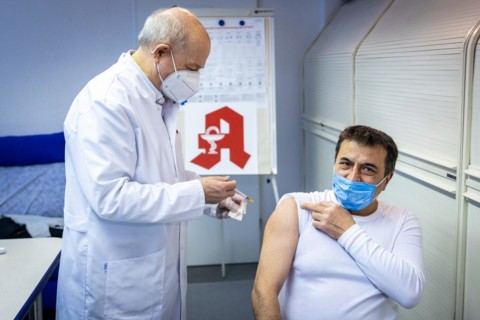 A pharmacist vaccinates a man with the Comirnaty BioNTech vaccine against the coronavirus in a pharmacy in Duesseldorf