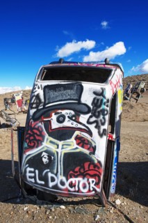 Cars sunk into the ground and sprayed with graffiti