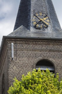Camouflaged antenna showing brick pattern from base station for mobile telephony on church tower