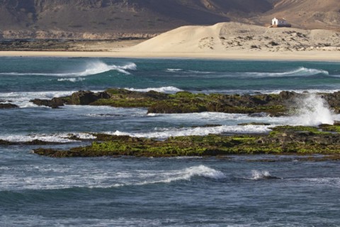 Praia de Fatima and abandoned chapel of Our Lady of Fatima looking over the rugged coast and cliffs near Sal Rei on the island Boa Vista