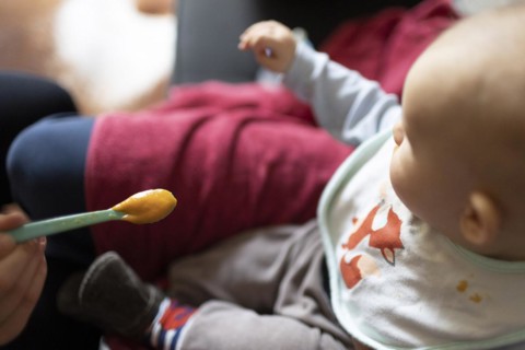 Child is fed with porridge