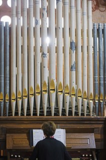 Organist playing Baroque pipe organ in the Jesuit Mission church of San Jose de Chiquitos