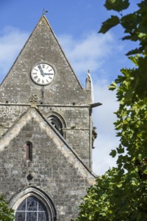 Sainte-Mere-Eglise church with Parachute Memorial in honour of paratrooper John Steele who was caught on the church spire during D-Day