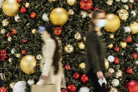 People stand out against Christmas decorations in a shopping centre on Schlossstrasse in Berlin
