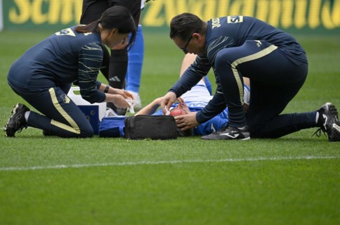 Attendants treat bleeding head wound after header duel of Finn Ole Becker TSG 1899 Hoffenheim