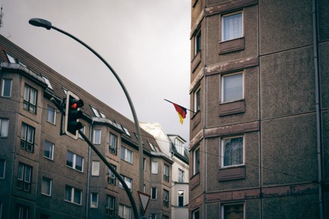 A German flag hangs from a residential building near Hackescher Markt in Berlin