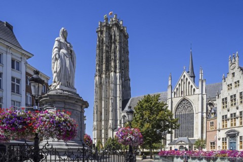 Statue of Archduchess Margaret of Austria and the St. Rumbold's Cathedral in the city Mechelen