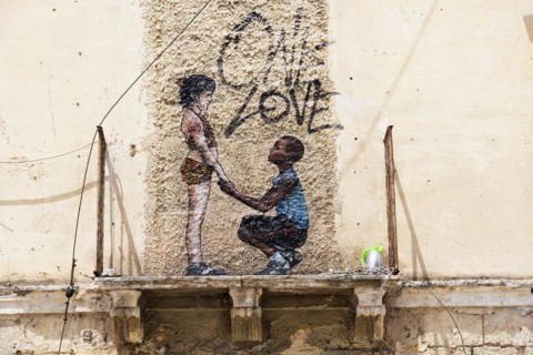 Mural One Love on weathered facade
