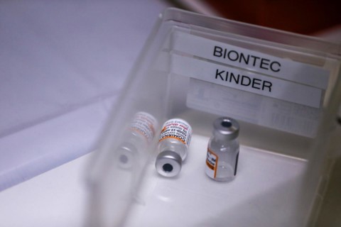 Used ampoules of the BioNTech Pfizer vaccine for children lie in a compartment in a COVID-19 vaccination and testing centre at the Olsen car dealership in Iserlohn