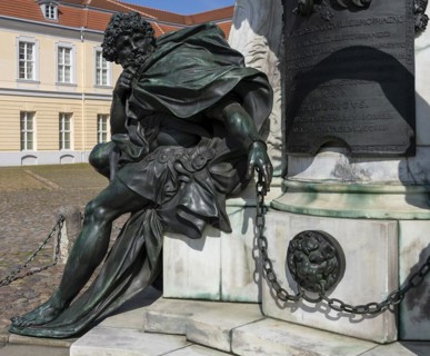 Detail photo of the chained warriors at the base of the equestrian statue of Frederick William of Brandenburg