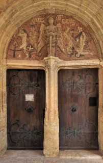 Old door and mosaic in the portal of the Saint Michael church