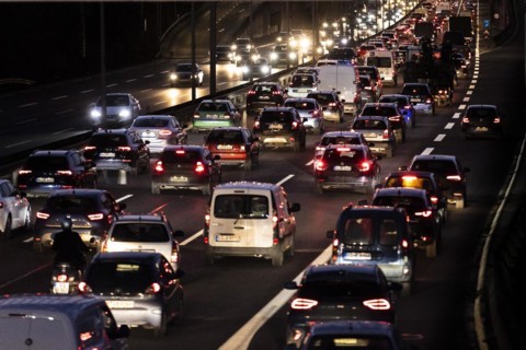 Congested traffic on the A100 looms at blue hour in Berlin