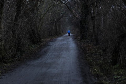 A man rides his bicycle along the Teltow Canal in Berlin