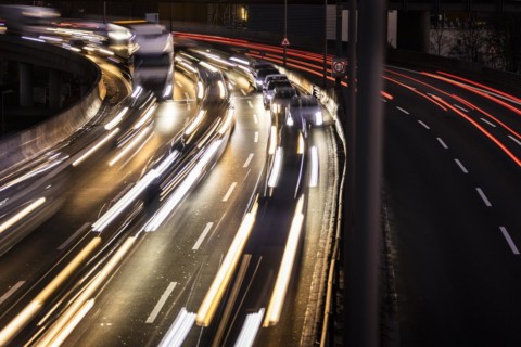 Congested traffic on the A100 looms at blue hour in Berlin