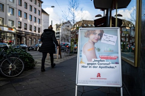 A poster at a pharmacy advertises the possibility to get vaccinated at pharmacies in Duesseldorf