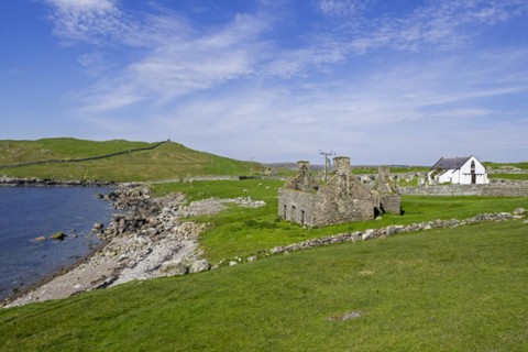 Ruin of old fishing booth and 18th century Lunna Kirk at East Lunna Voe