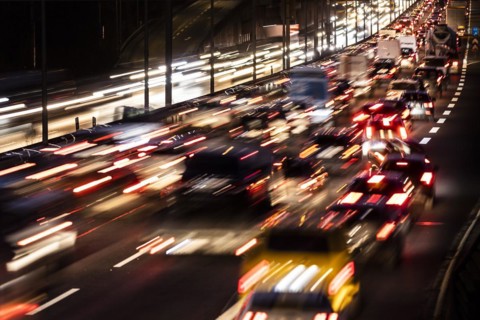 Congested traffic on the A100 looms at blue hour in Berlin