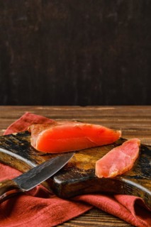Air dried turkey breast on wooden cutting board with place for text
