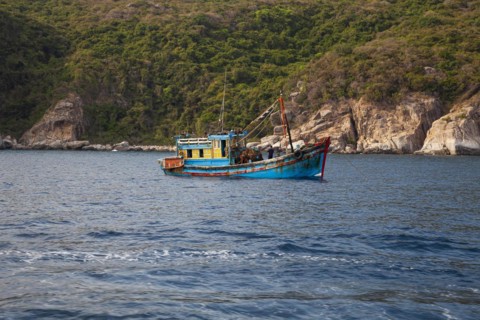 Fishing boat at Rocky coastal landscape
