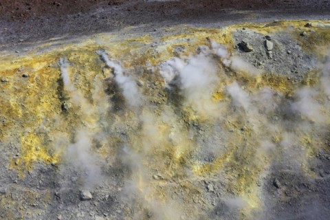Smoking sulphur fumaroles at the crater rim