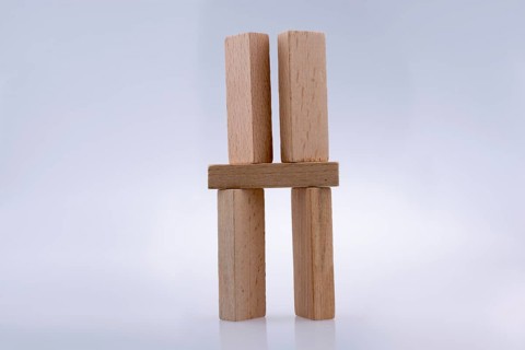 Wooden domino pieces positioned on white background