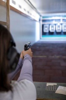 Woman Shooting with a Gun in Shooting Range with Target in Switzerland
