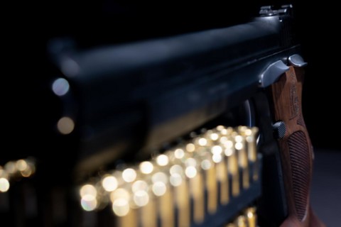 Elegant Semiautomatic 9mm Handgun with Swiss Helvetia Symbol Leaning on Bullet Ammunition in Switzerland