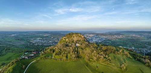 Aerial panorama of the volcanic cone Hohentwiel with the castle ruins illuminated by the evening sun