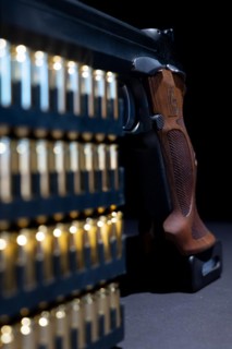Elegant Semiautomatic 9mm Handgun with Swiss Helvetia Symbol Leaning on Bullet Ammunition in Switzerland