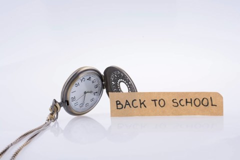 Back to school written title and a pocket watch