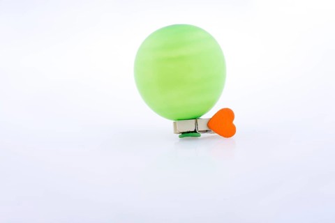 Clothespin with a heart and a balloon on white background