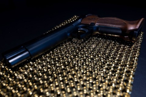 Elegant Semiautomatic 9mm Handgun with Swiss Helvetia Symbol Leaning on Bullet Ammunition in Switzerland