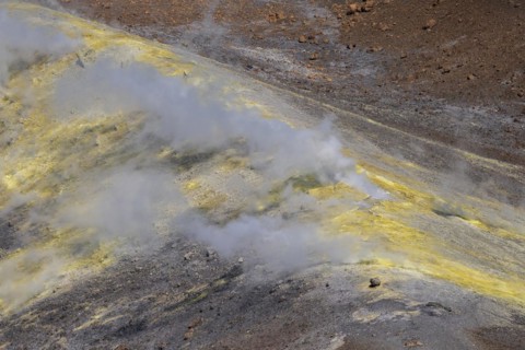 Smoking sulphur fumaroles at the crater rim