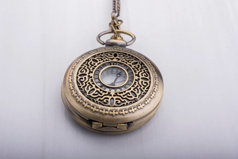 Retro style pocket watch on white background
