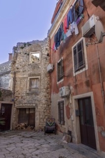 Laundry is hung out to dry on a line on an old house in an alleyway in the coastal town of Umag