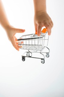 Shopping cart in the hand on white background