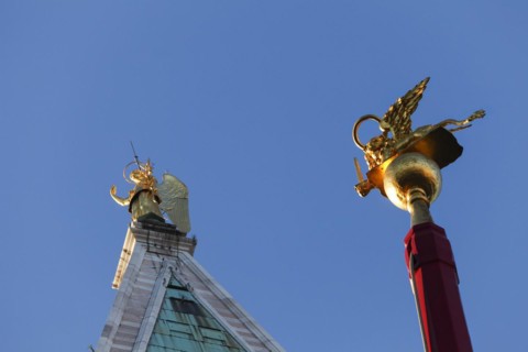 Campanile with the gilded Archangel Gabriel and flagpole with St Mark's lions on the Piiazza San Marco