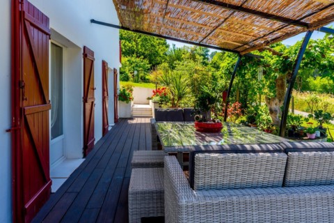 Summer house terrace. Terrace next to the vegetation of the garden in the shade of the sun