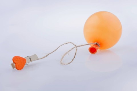Clothespin with a heart tied to a balloon with a string